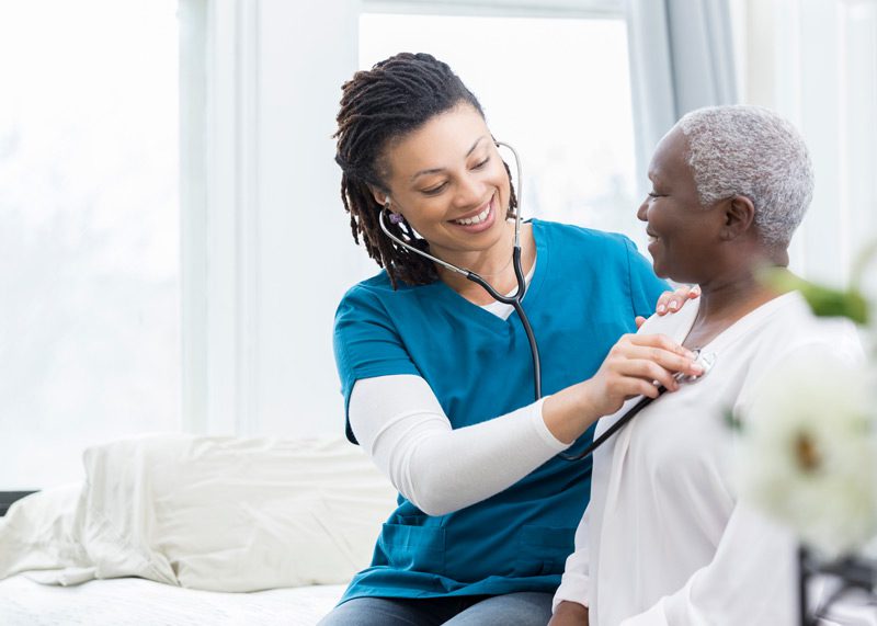 home health aide checking patients vital signs